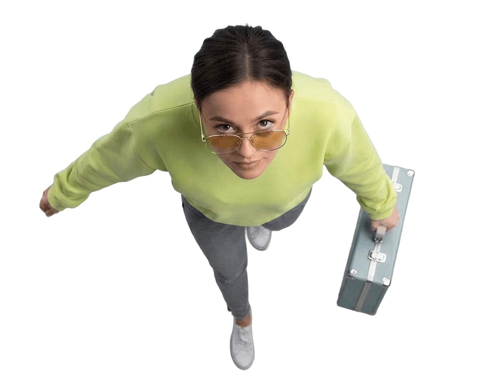 Person in a lime sweater holding a suitcase